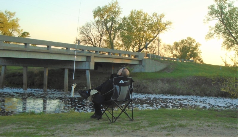 A fisherman enjoys the peace and quiet at Atkinson Mill Race Park & Campground.